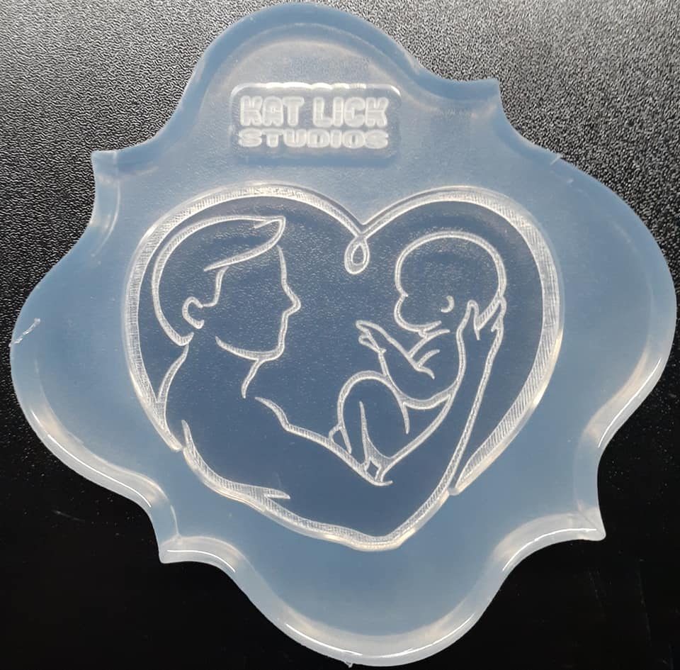 2.5 Dad and Baby in a Heart Shape Mold Made w/Crystal Clear Platinum Silicone